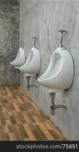 three white urinals men public toilet in restroom outdoors. three white urinals