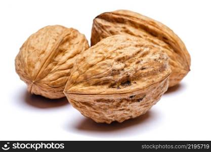 three whole walnuts isolated on white background. clipping path embeeded. three whole walnuts isolated on white background. clipping path