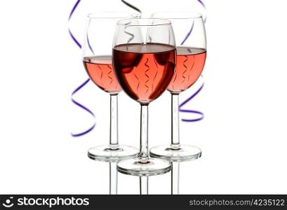 Three wine glasses with rose wine and party streamers isolated on white background with copy space.