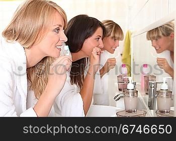 Three women brushing their teeth