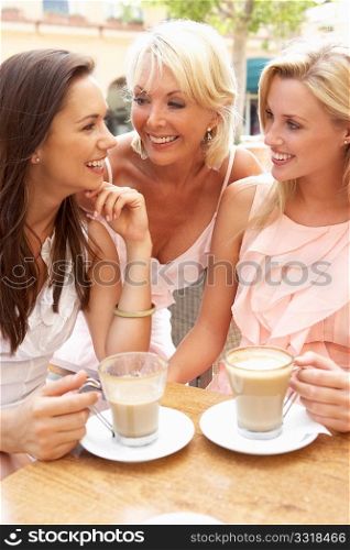 Three Women Enjoying Cup Of Coffee In CafZ