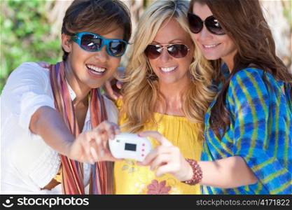 Three Women Friends Taking Pictures of Themselves on Digital Camera