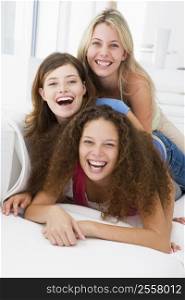 Three women in living room playing and smiling