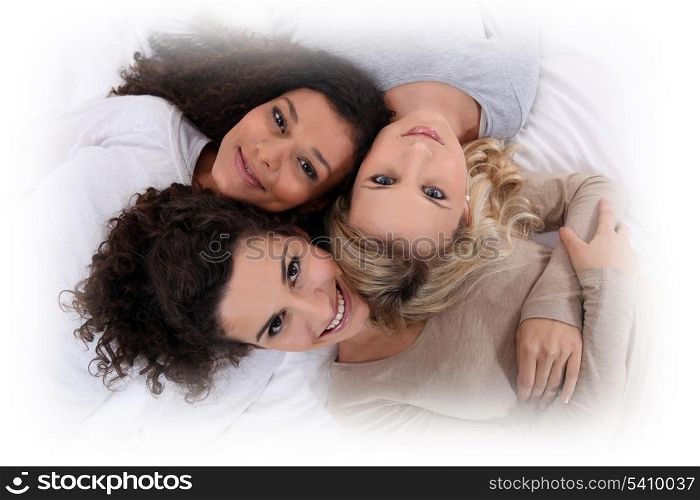 Three women laying next to each other