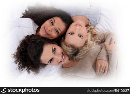 Three women laying next to each other