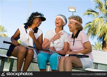 Three women on tennis court