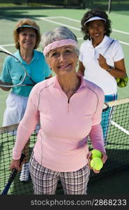 Three women on tennis court, portrait