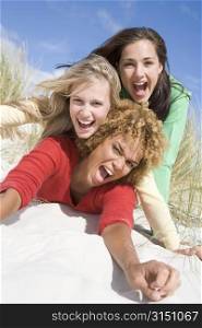 Three women posing on a sand hill