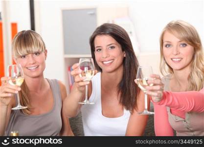Three women toasting with glass of wine