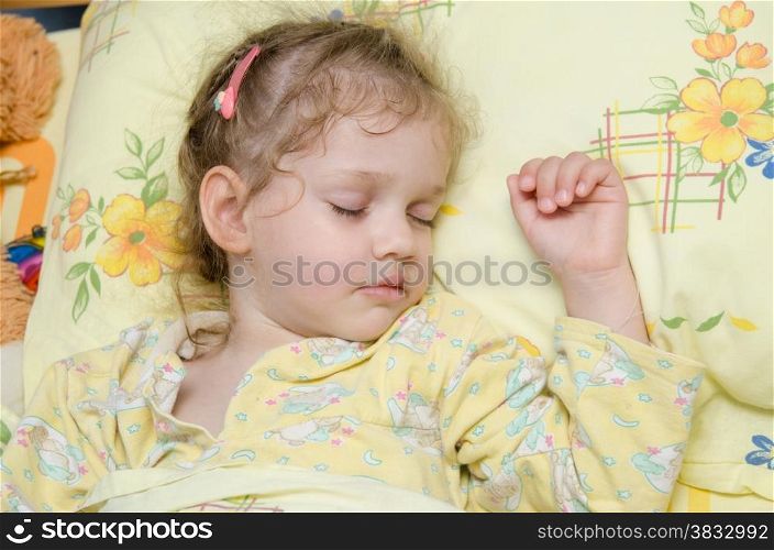 Three year old girl sweetly asleep in his crib in the nursery