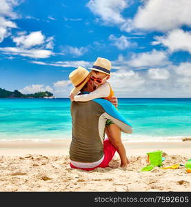 Three year old toddler boy on beach with father. Summer family vacation at at Seychelles, Mahe.