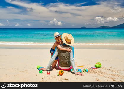 Three year old toddler boy on beach with father. Summer family vacation at at Seychelles, Mahe.