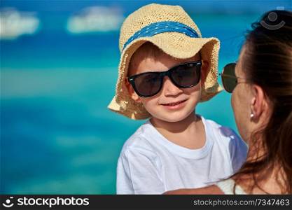 Three year old toddler boy on beach with his mother. Summer family vacation at Maldives.
