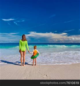 Three year old toddler boy on beach with mother. Summer family vacation at at Seychelles, Mahe.