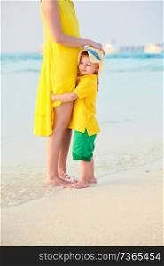 Three year old toddler boy on beach with mother. Summer family vacation at Maldives.