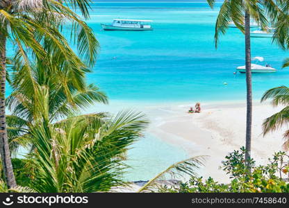 Three year old toddler boy on beach with mother. Summer family vacation at Maldives.