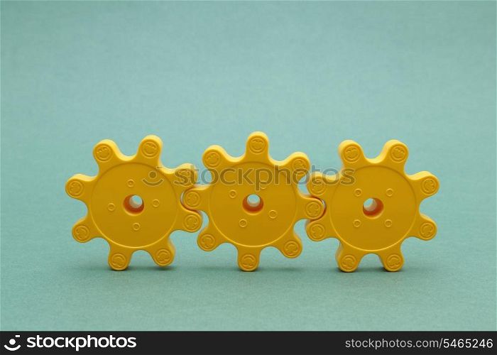 Three yellow plastic gears