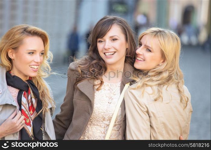 Three young beautiful women smiling
