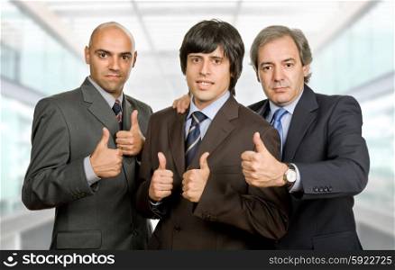 three young business men going thumbs up, at the office