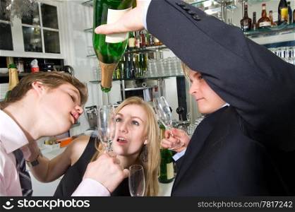 three young, drunken adults taking the last drop of champagne at a bar