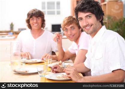 Three young men having lunch