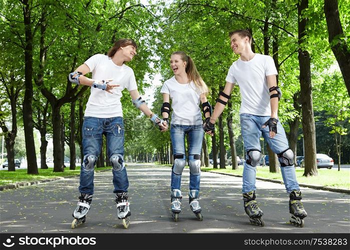 Three young people go for a drive on rollers