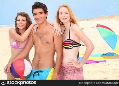 Three young people hanging out on the beach