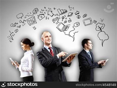 Three young people in business suits. Three young people in business suits with tablet pc in hands