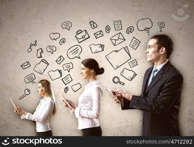 Three young people in business suits. Three young people in business suits with tablet pc in hands