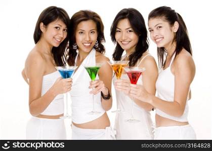 Three young women and a teenage girl holding cocktails and smiling