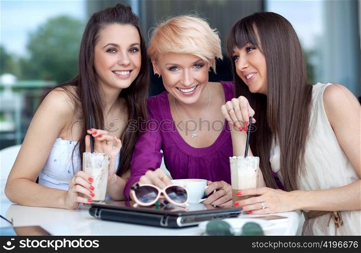 Three young women having coffee break
