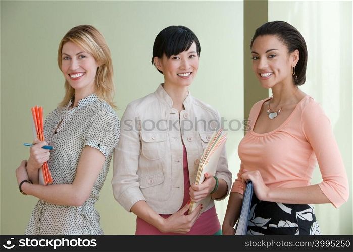 Three young women posing indoors