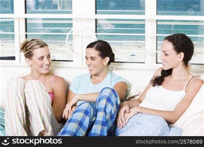Three young women sitting together