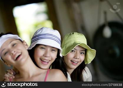 Three young women smiling