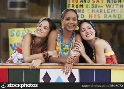 Three young women smiling in the balcony