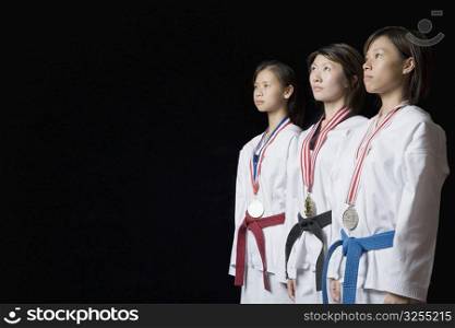 Three young women standing with their medals