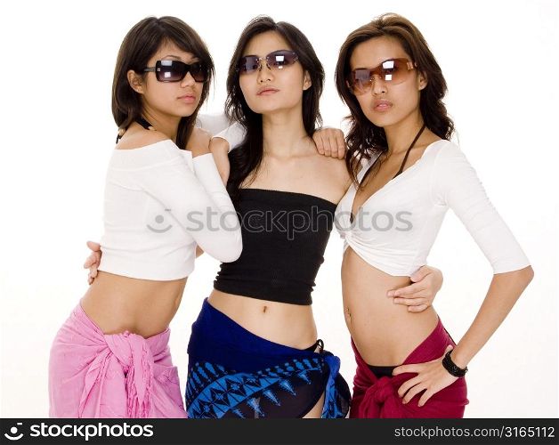 Three young women wearing sunglasses and posing