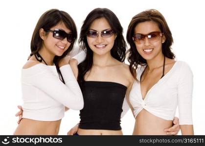Three young women wearing sunglasses and smiling