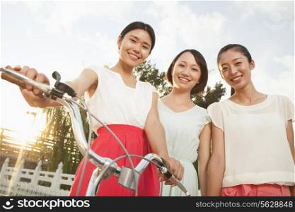 Three Young Women with Bicycle