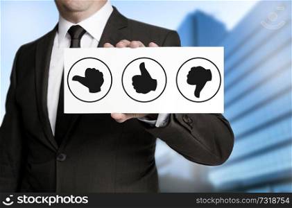 Thumbs concept placard is held by businessman.. Thumbs concept placard is held by businessman