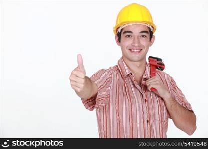 Thumbs up from a young construction worker