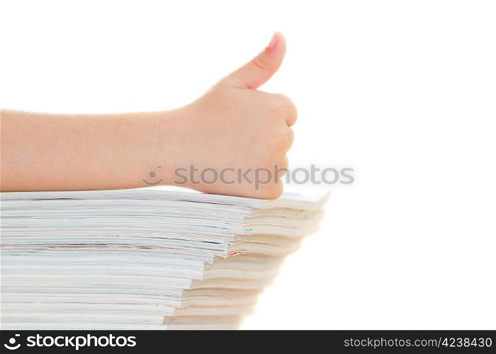 Thumbs up. Hand of child on the magazines.