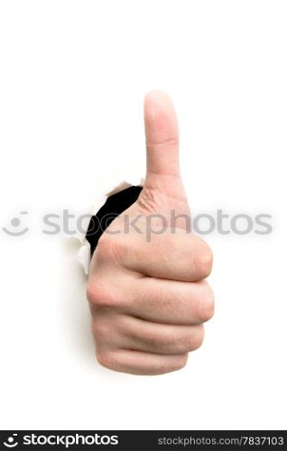 Thumbs up through the paper hole isolated on white background