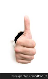 Thumbs up through the paper hole isolated on white background