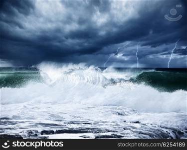 Thunderstorm and lightning on the beach, dark night scene with cloudy rainy stormy landscape, beautiful powerful forces of nature, seascape with high surfing waves, cold dramatic ocean