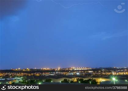 thunderstorm at night with city lights background