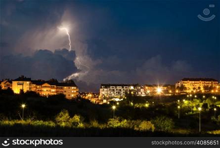 thunderstorm over night city with massive lightning bolt