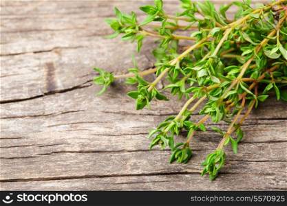 Thyme on the rustic wooden table close up
