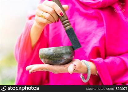 Tibetan bell in hand and played