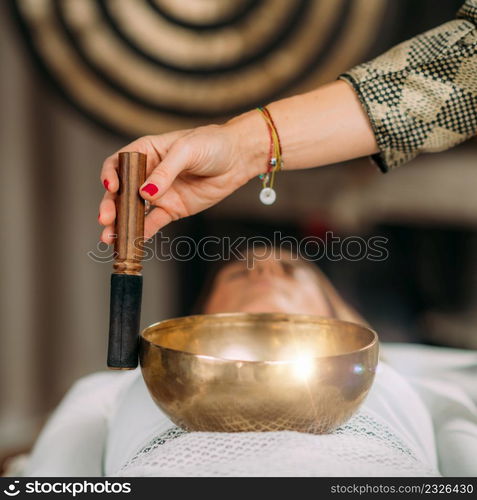 Tibetan singing bowl in sound healing therapy. Sound Therapy with Tibetan Singing Bowl